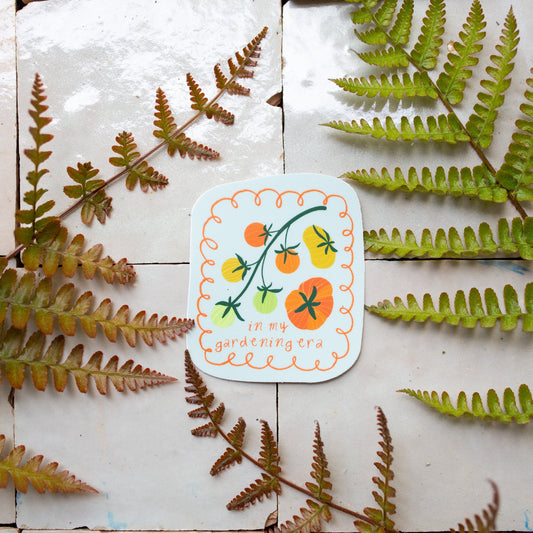 gardening themed sticker with illustrated tomatoes on a light blue background and playful lettering, a perfect gift for plant lovers and gardeners
