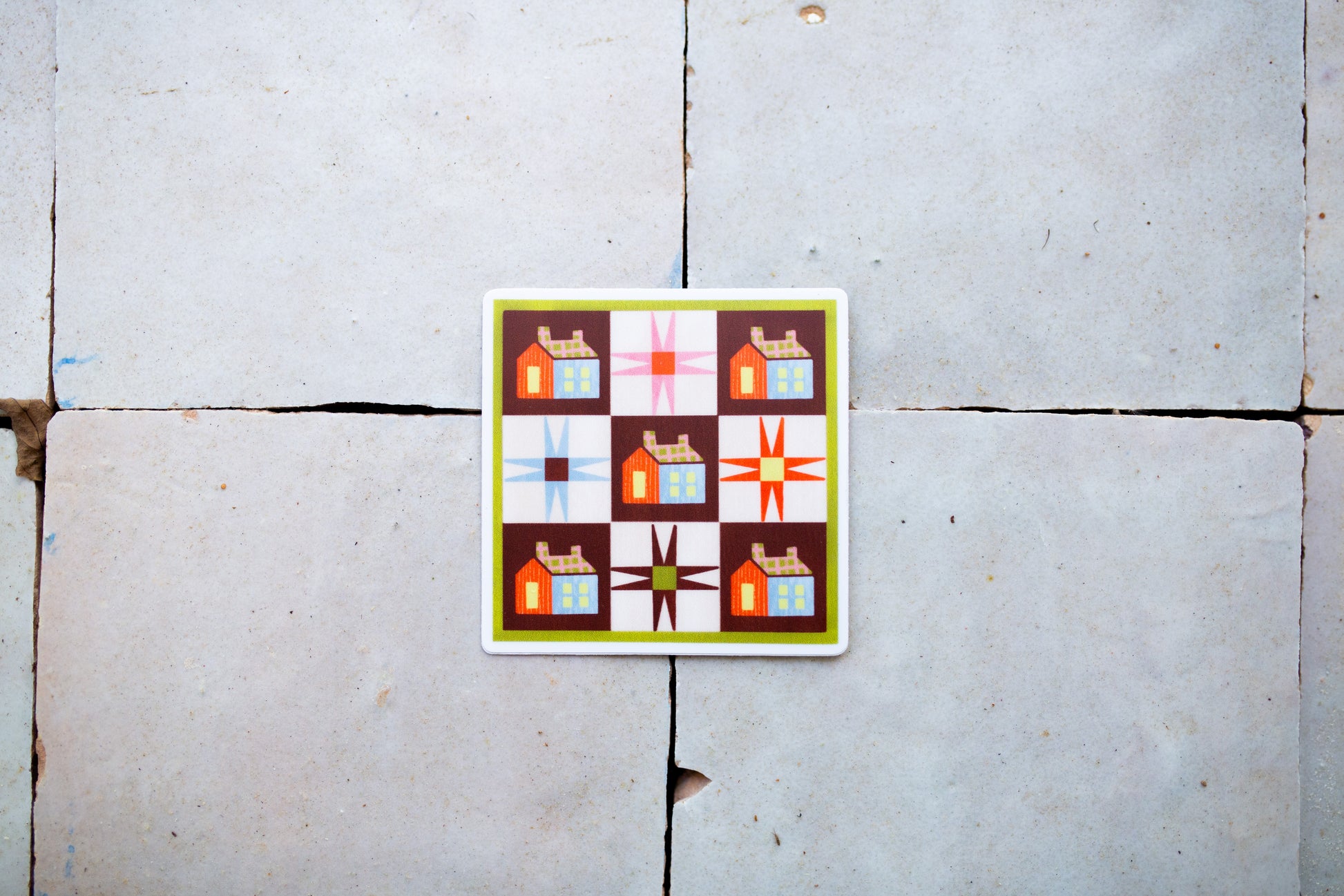 Colorful quilt patterned sticker on a tile surface