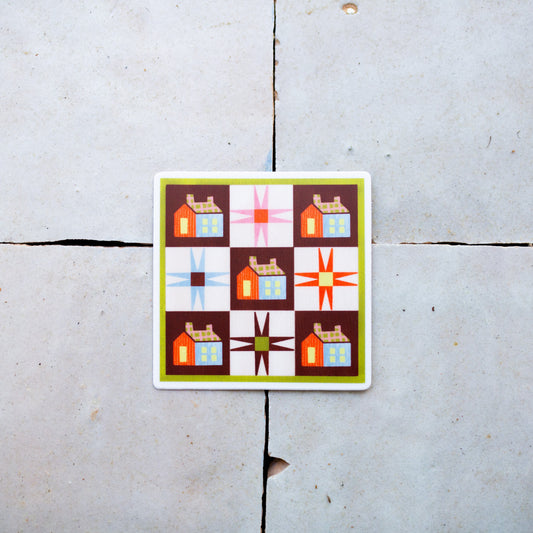 Colorful quilt patterned sticker on a tile surface