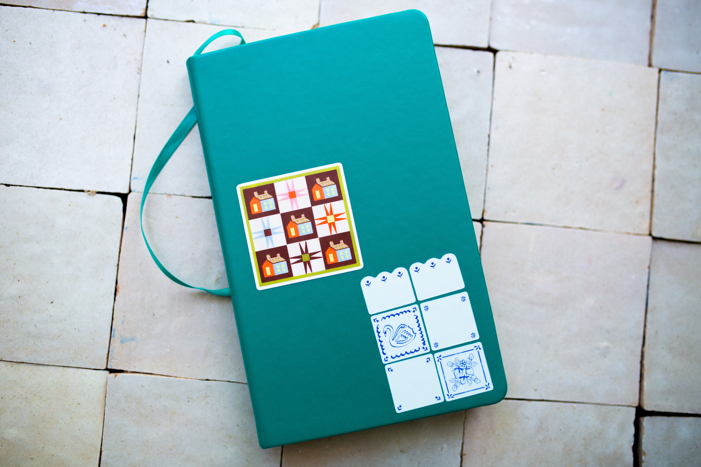 Green notebook with quilt design stickers