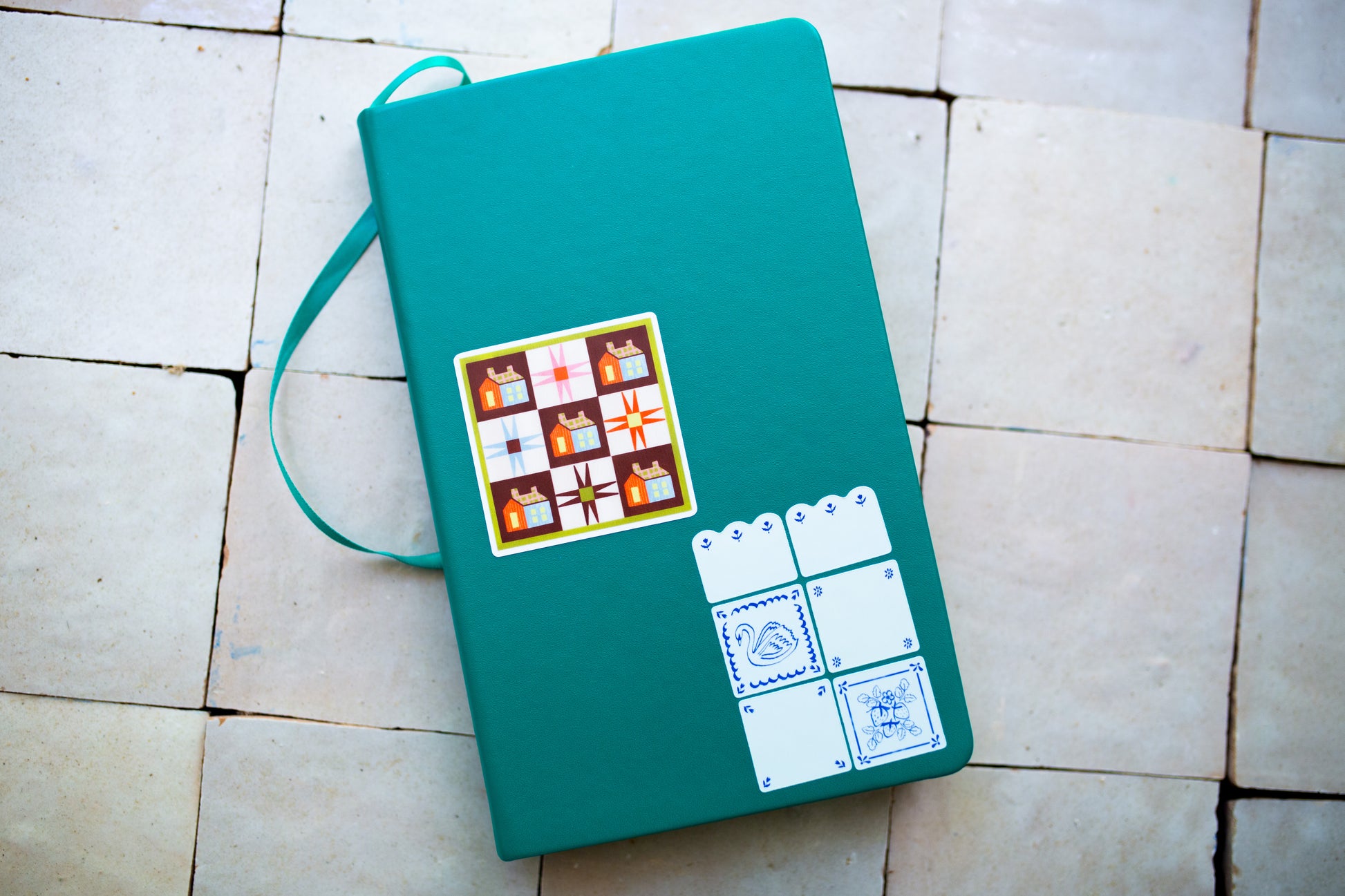 Green notebook with quilt design stickers