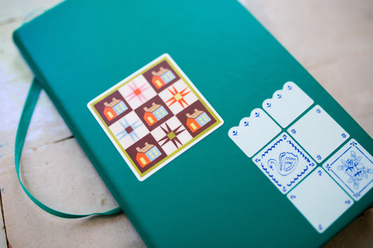 Green notebook with decorative quilt sticker 