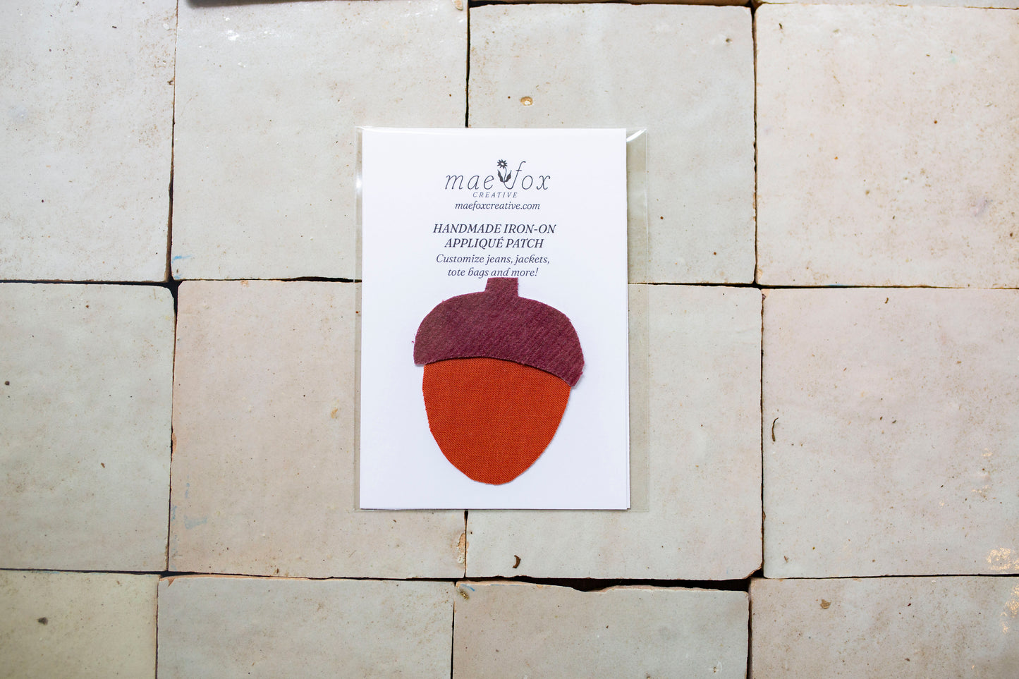 Handmade appliqué patch shaped like an acorn, crafted from mixed vintage fabrics  slightly imperfect, charming handmade finish, designed for decorating jackets, jeans, or tote bags.