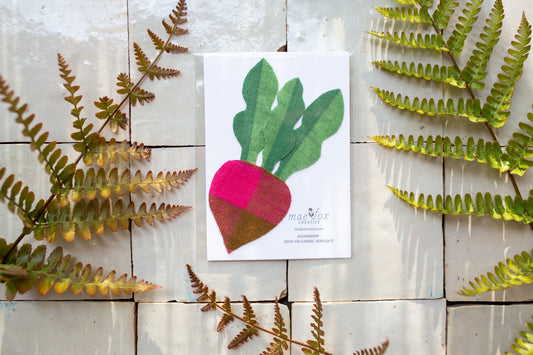 iron-on fabric patch featuring a stylized beet root with leafy green stems, designed for easy application to clothing or accessories.