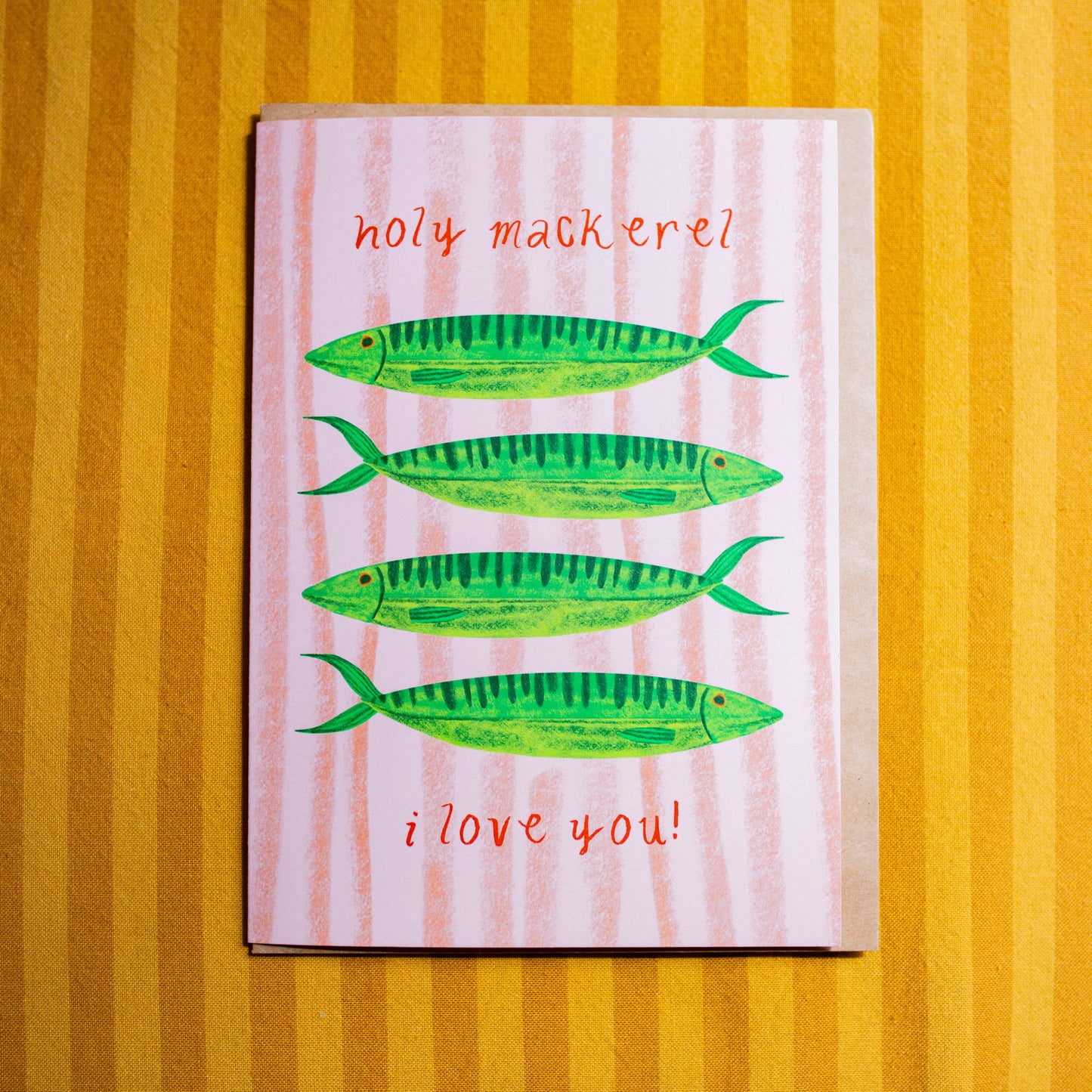 Card with green fish illustrations and text on a striped background