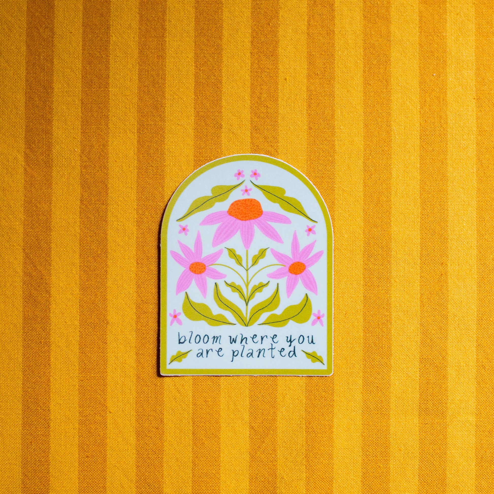 Decorative sticker with floral design and text on a striped yellow background