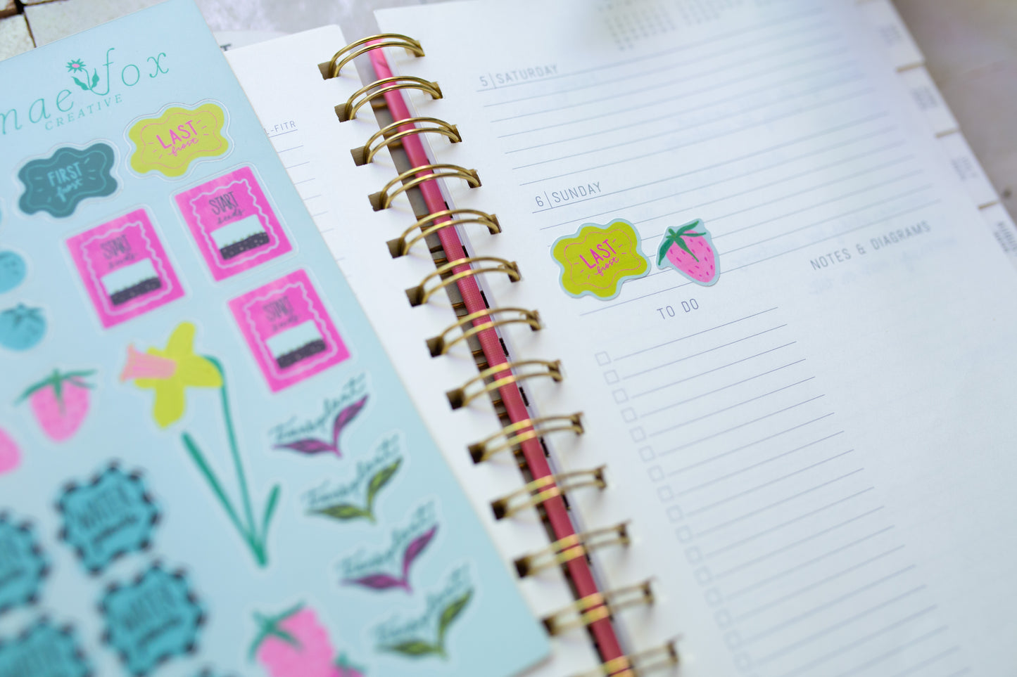 Planner with colorful stickers on a white surface