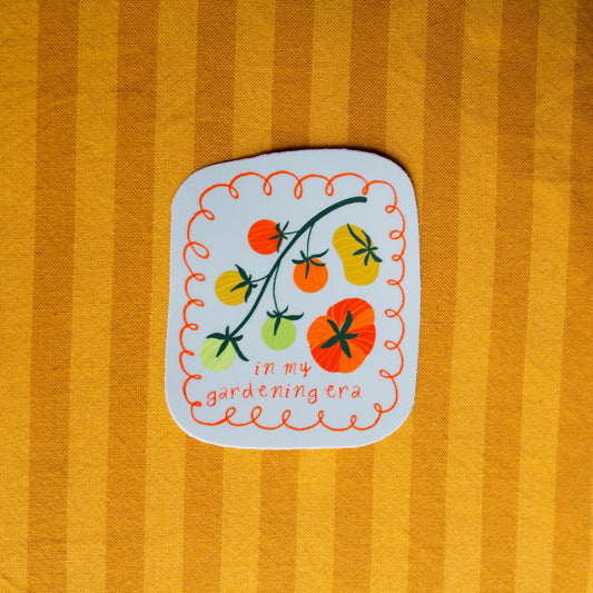 Sticker with tomato design on a striped yellow background