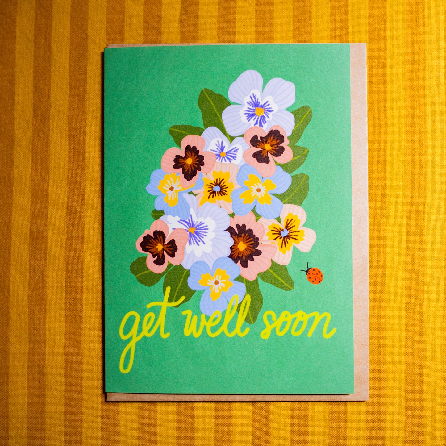 Card with floral design and 'get well soon' text on a striped background