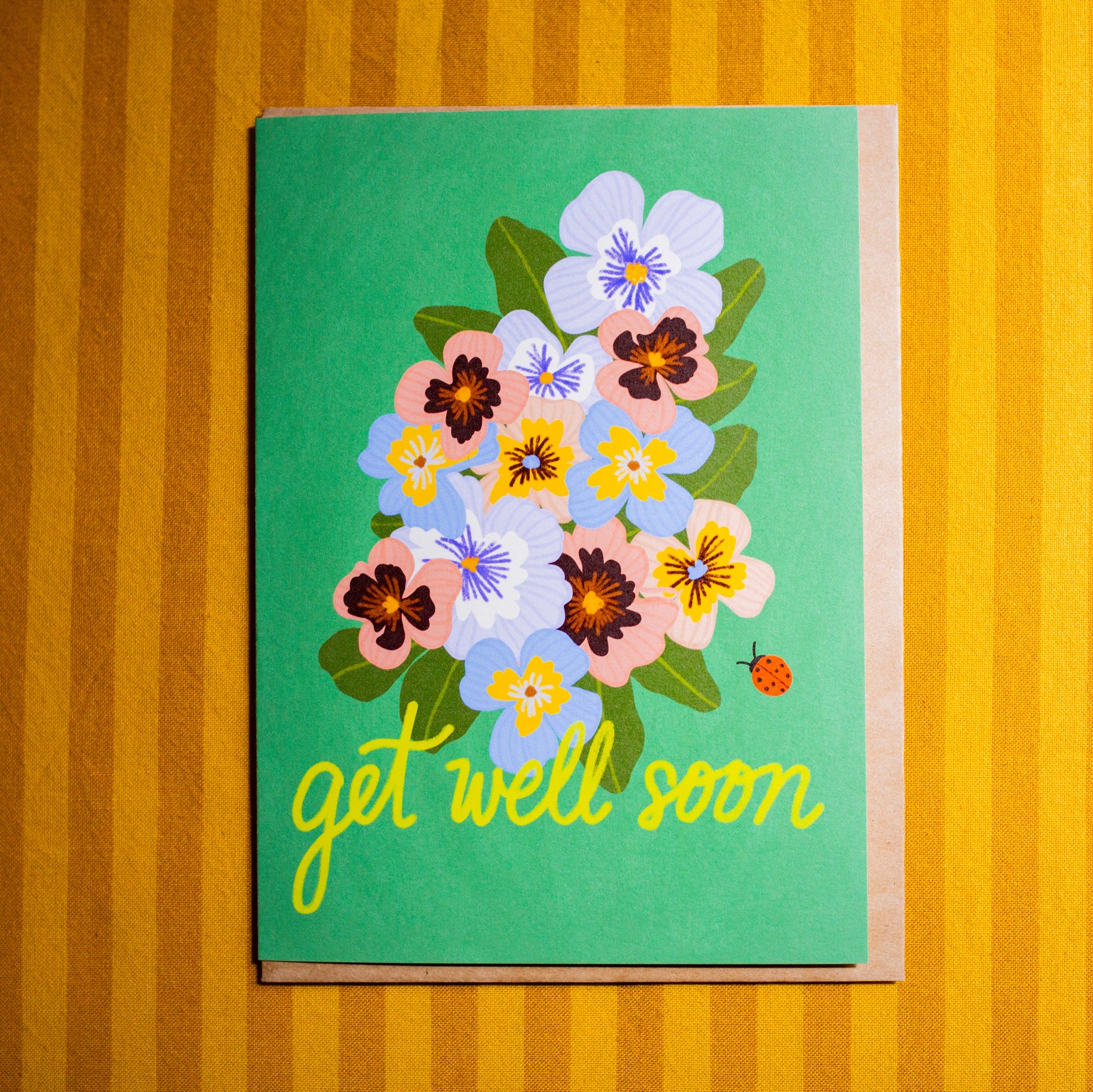 Card with floral design and 'get well soon' text on a striped background