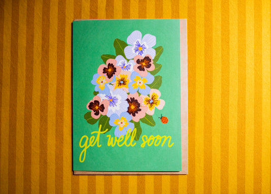 Card with floral design and 'get well soon' text on a striped background