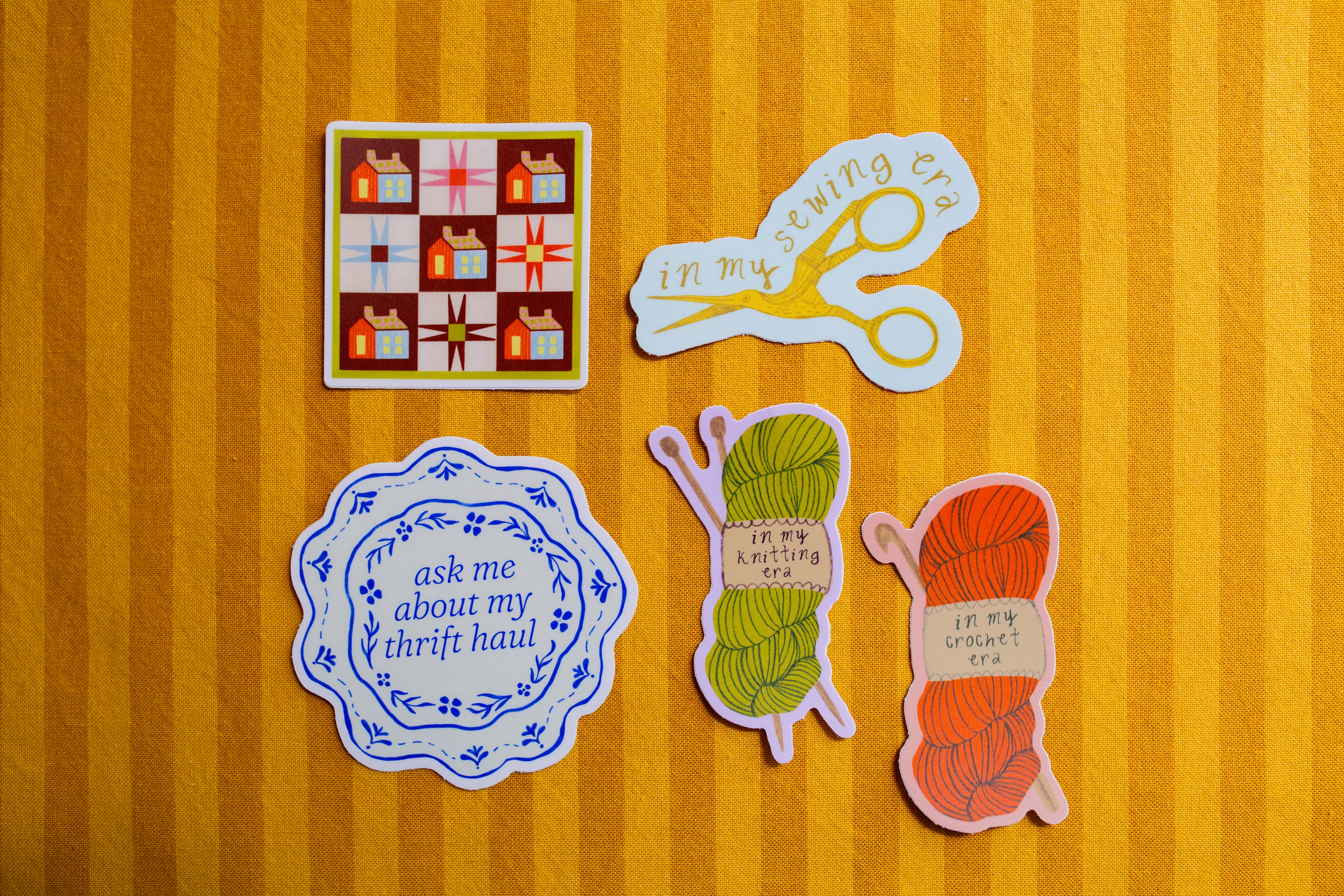 Set of five colorful stickers on a striped orange and yellow background