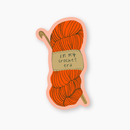 Sticker of orange yarn skein with a crochet hook and 'in my crochet era' label on a white background