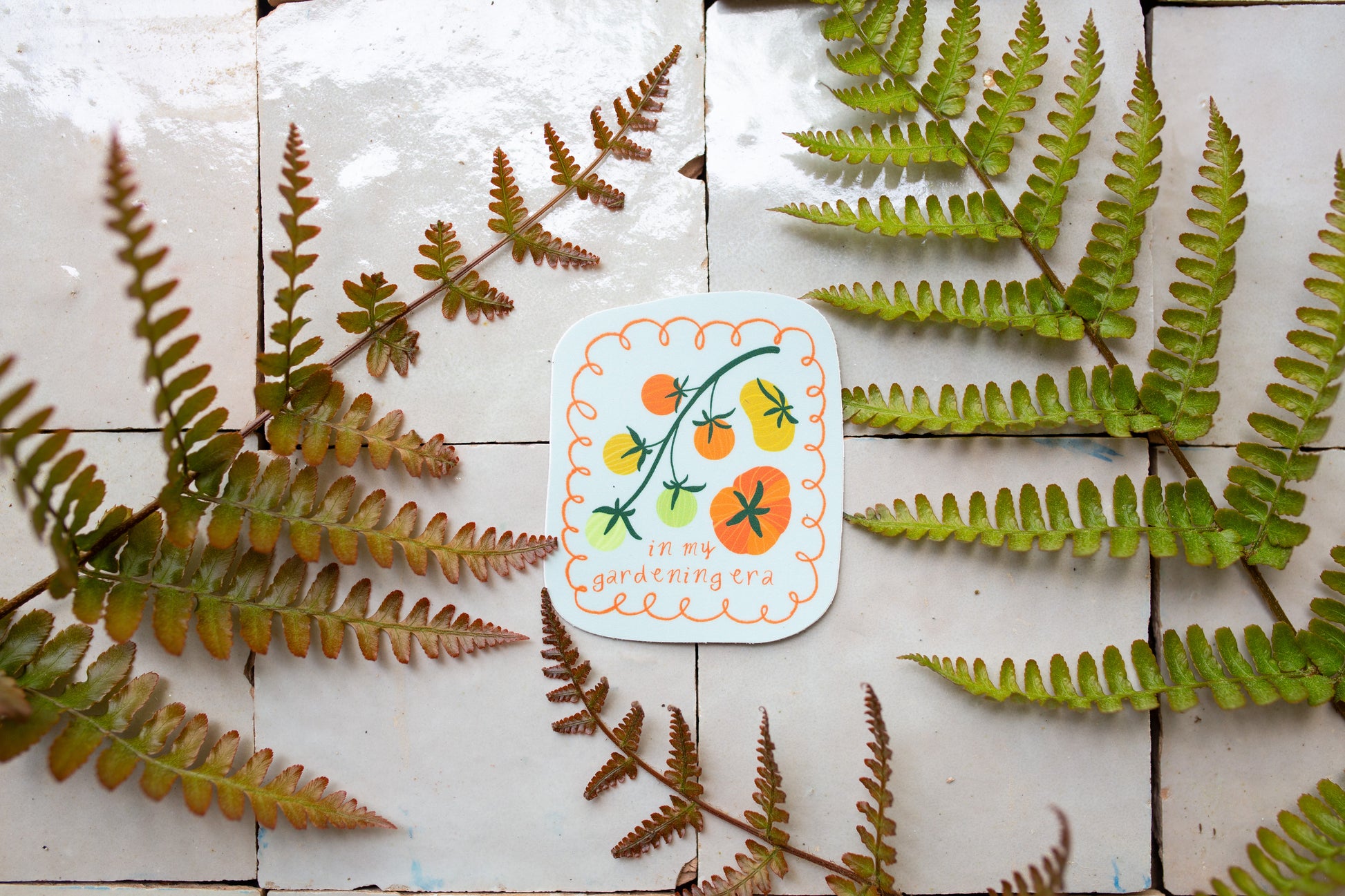 gardening themed sticker with illustrated tomatoes on a light blue background and playful lettering, a perfect gift for plant lovers and gardeners