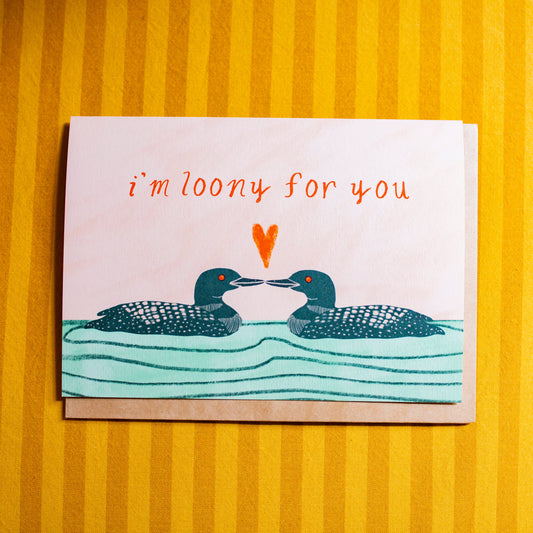 Card with loon illustration and text 'i'm loony for you' on a yellow striped background