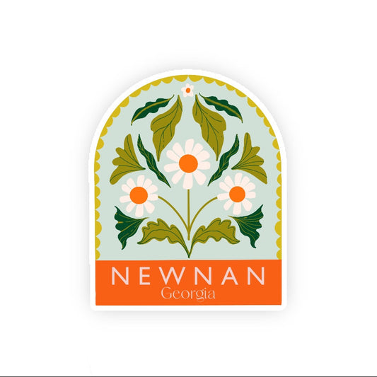 Decorative sticker with floral design and 'Newnan Georgia' text on a light blue background