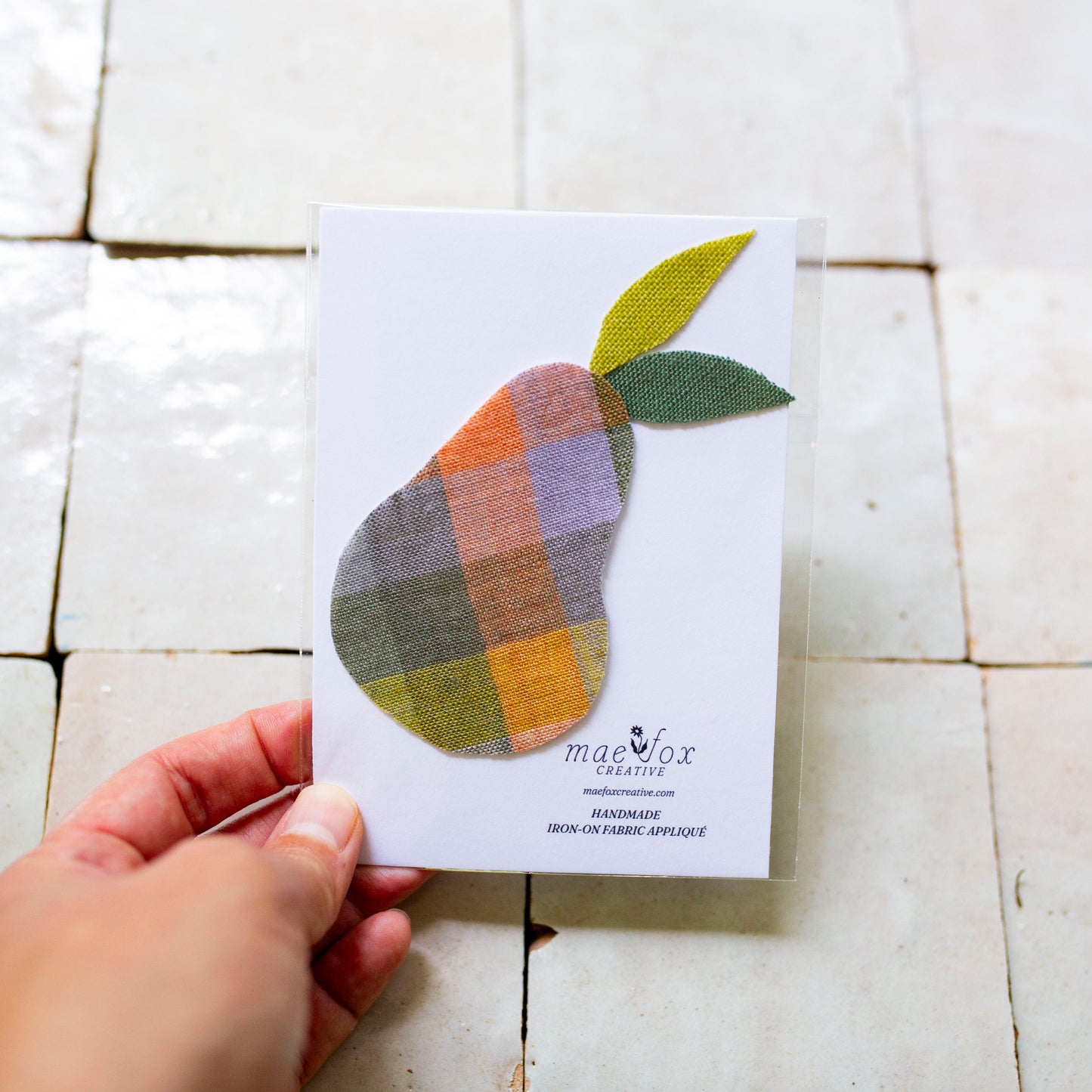 Handmade appliqué patch shaped like pear, crafted from vintage and scrap fabric, slightly imperfect, charming handmade finish, designed for decorating jackets, jeans, or tote bags.
