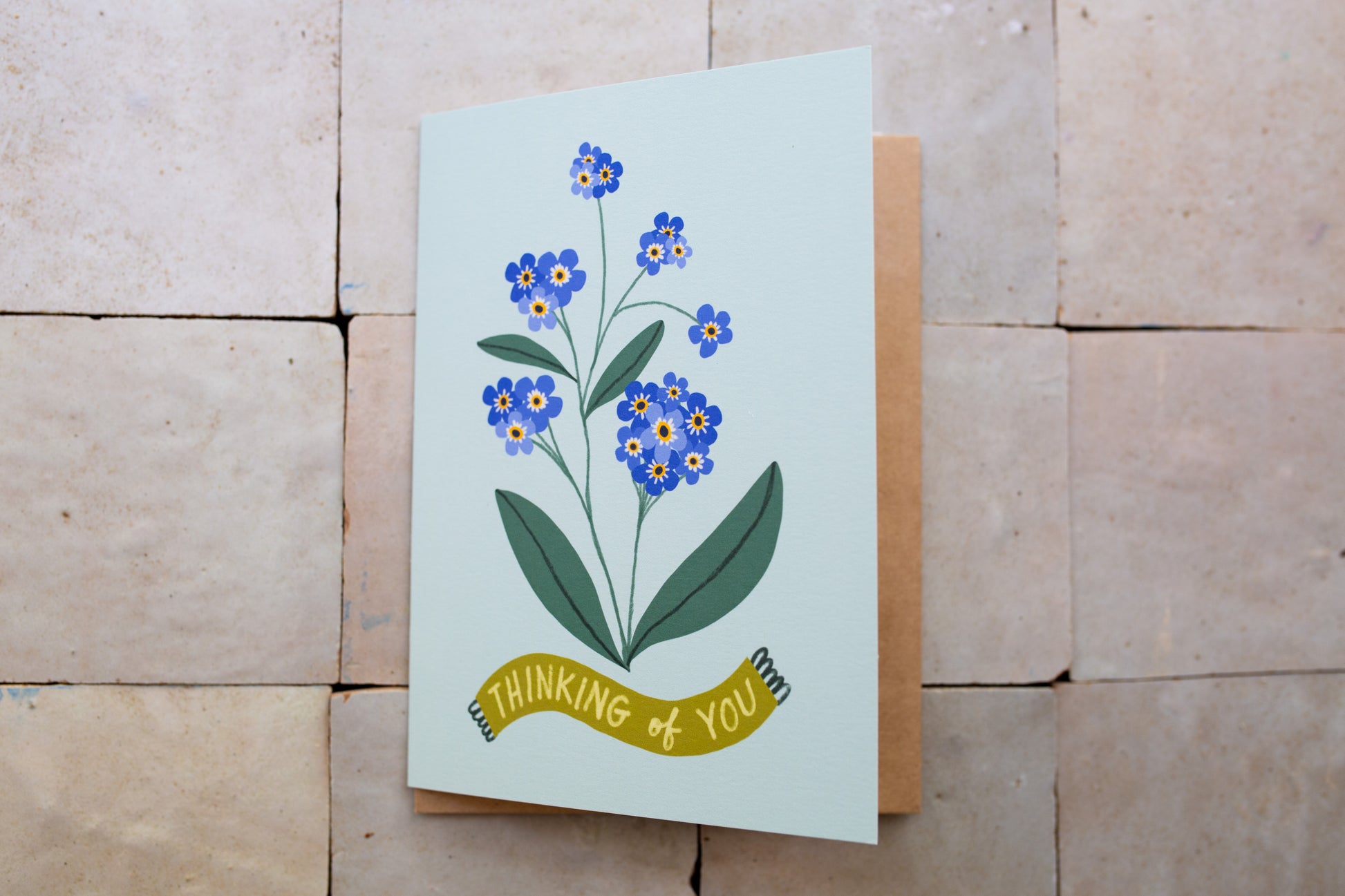 Greeting card with floral design and 'thinking of you' text 