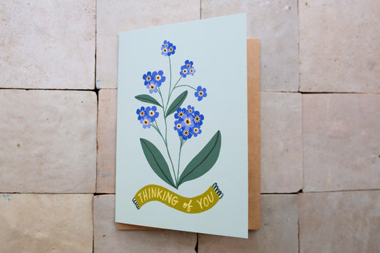 Greeting card with floral design and 'thinking of you' text 