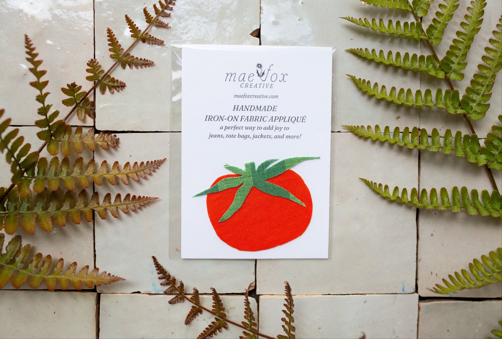 Handmade tomato-shaped appliqué patch made from vintage red and green fabrics