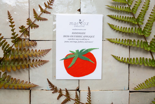 Handmade tomato-shaped appliqué patch made from vintage red and green fabrics