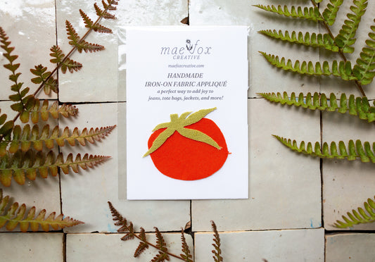 Handmade tomato-shaped appliqué patch made from vintage red and green fabrics