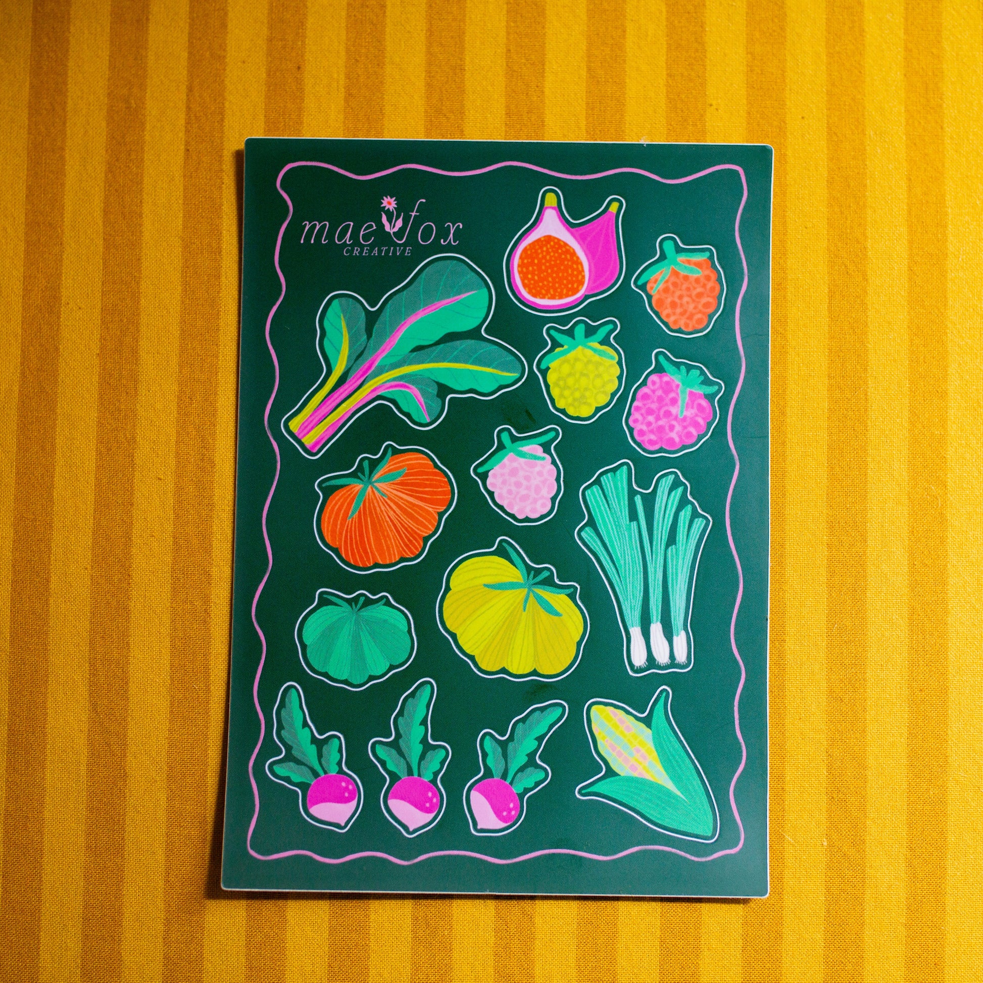 Sticker sheet with colorful vegetable illustrations on a yellow striped background
