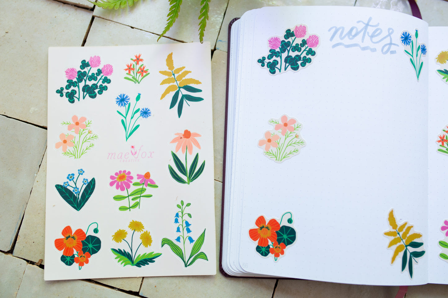 Notebook with floral stickers on a tiled floor