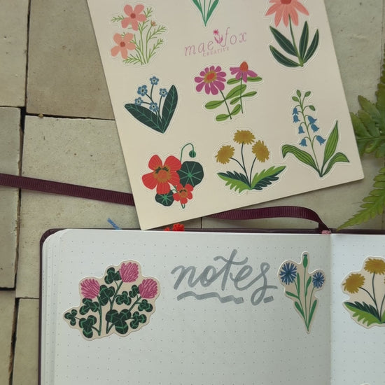 video of wildflower stickers on a notebook