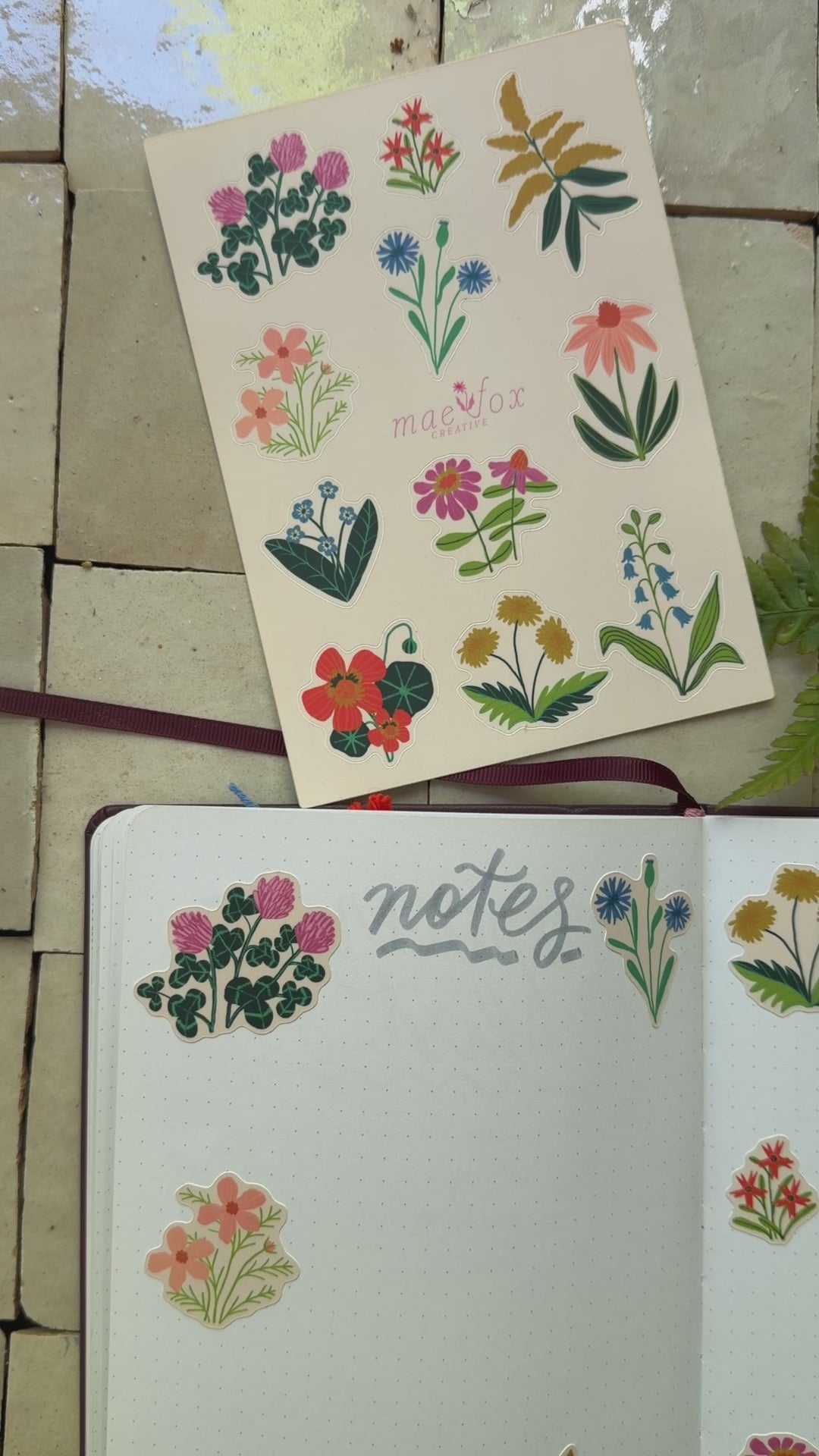 video of wildflower stickers on a notebook